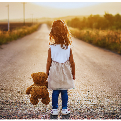 image of a child holding a teddy bear