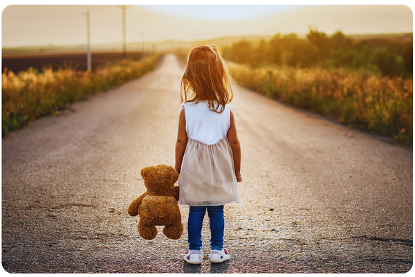 image of a child holding a teddy bear