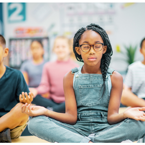 image of children in a classroom doing a mindfulness breathing exercise
