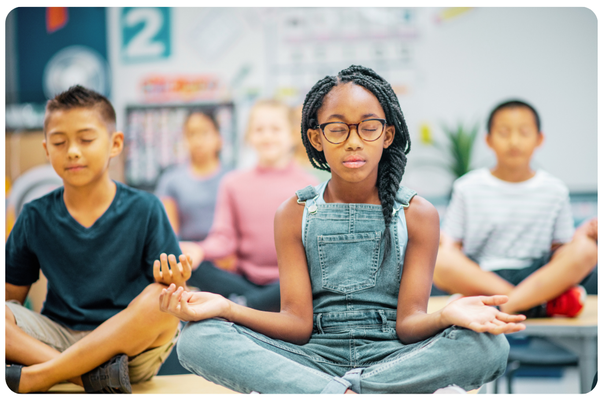 image of children in a classroom doing a mindfulness breathing exercise