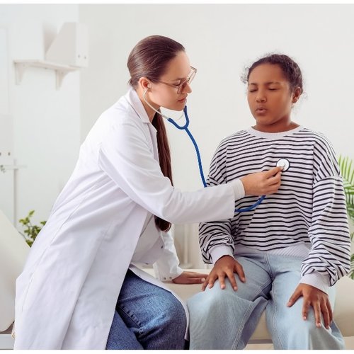 Photo of a physician examining a pediatric patient